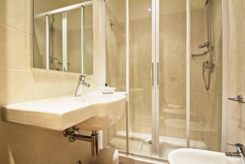 a bathroom with a sink and a shower at Hotel Primula in Alassio