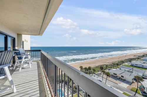 a balcony with a view of the beach at Sunrise beach views with top complex amenities and pool access! in Ormond Beach
