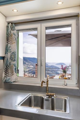 a kitchen sink with a window with a view at Larimis House in Loutraki