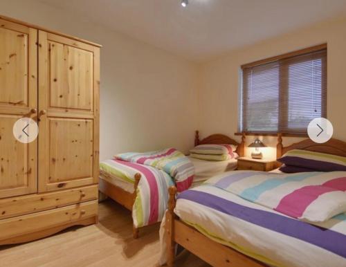 a bedroom with two beds and a large window at Eureka Whitsands in Antony