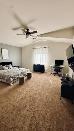 a bedroom with a bed and a ceiling fan at 4bed 2bath Retreat - 120inch Theater in Corona de Tucson