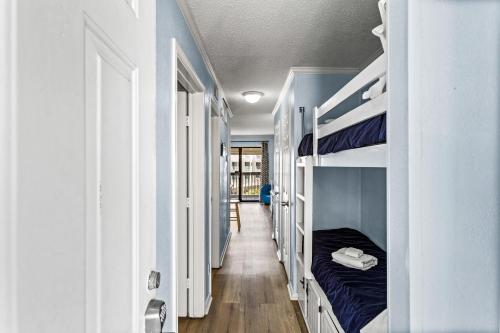 a hallway with bunk beds in a room at Heated Pool Beach View Beachside Haven Balcony in Galveston