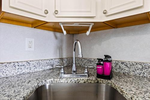 a kitchen counter with a sink and a faucet at Heated Pool Beach View Beachside Haven Balcony in Galveston