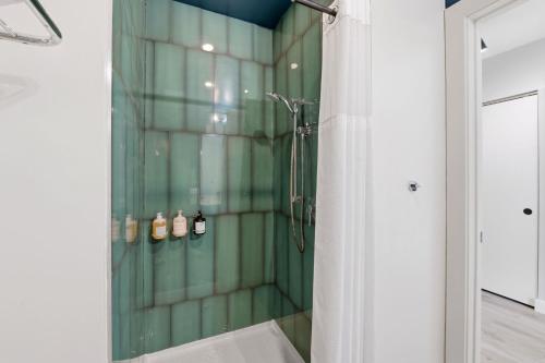 a bathroom with a shower with a glass wall at The Plymouth Chicago in Chicago