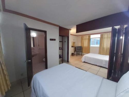 a hotel room with a bed and a bathroom at Hotel Estación Guadalajara in Guadalajara