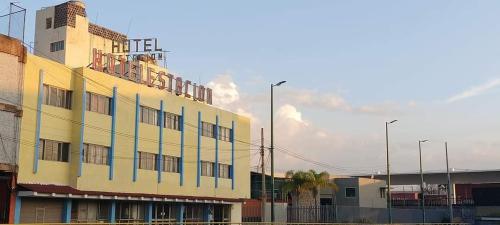 a yellow building with a balcony on top of it at Hotel Estación Guadalajara in Guadalajara