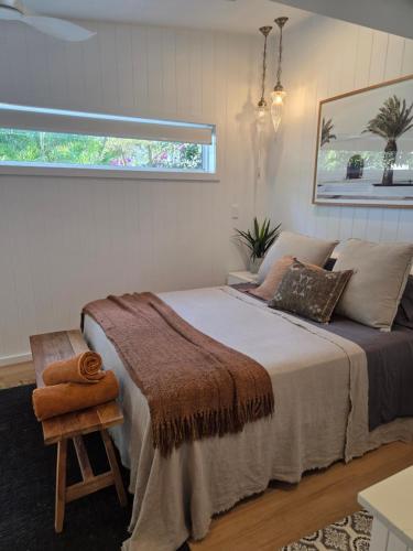 a bedroom with a large bed and a window at Seaclusion at Byron in Byron Bay
