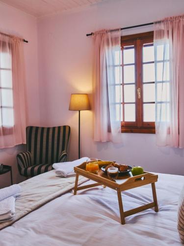 a room with a bed with a tray of food on it at Marilion Villa in Ioannina