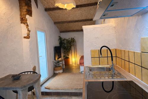 a kitchen with a sink and a table at Encanto do frade in Carrapatelo