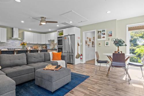 a living room with a couch and a table and a kitchen at Kayaks & River Access Easy Parking Beautiful in Gladwyne