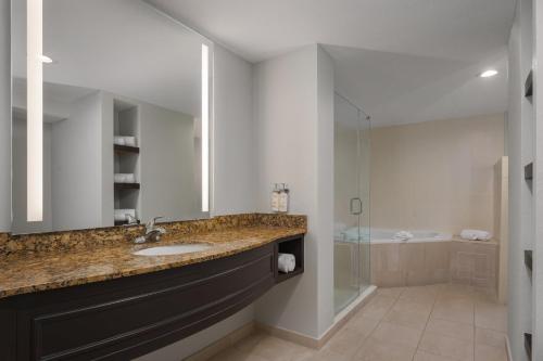 a bathroom with a sink and a shower at Holiday Inn Express & Suites Miami Kendall by IHG in Kendall