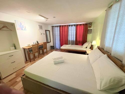 a bedroom with a bed and a desk in it at Island - Escape Homestay in Burgos
