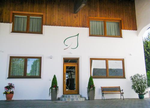 a white building with a sign on the side of it at Gästehaus am Lindenhain in Erding