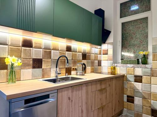 a kitchen with green cabinets and a sink at Федорцьо in Mukacheve