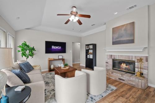 a living room with a couch and a fireplace at Modern Home Close to It All in DFW Texas! in Grand Prairie