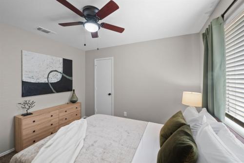 a bedroom with a bed and a ceiling fan at Modern Home Close to It All in DFW Texas! in Grand Prairie