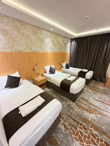 a hotel room with two beds in it at Etqan Al Mashair Two in Mecca