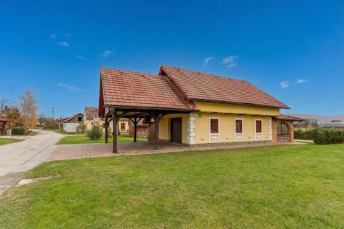 a house with a brown roof on a green field at Forge of Happiness Rustic Retreat - Happy Rentals in Gradac