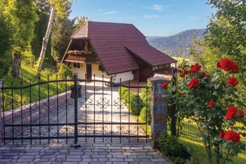 a gate to a house with a house at Forest Retreat Bonidesa - Terrace & Jacuzzi - Happy Rentals in Ljubno