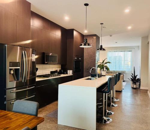 a kitchen with a white counter and a refrigerator at Modern House with Aurora Views in Yellowknife