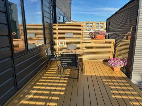 a balcony with two chairs and a table on a building at Modern House with Aurora Views in Yellowknife