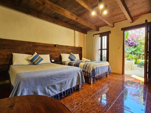 a bedroom with two beds in a room at Arte Sano Hotel San Cristobal in San Cristóbal de Las Casas