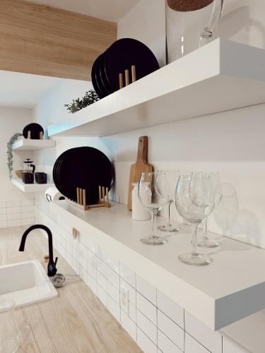 a kitchen with wine glasses on a counter at California Suite in Fort Saint John