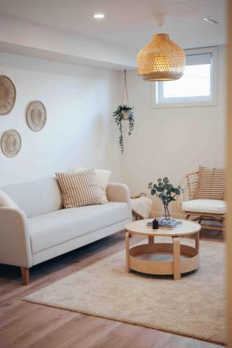 a living room with a white couch and a coffee table at California Suite in Fort Saint John