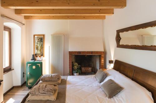a bedroom with a large bed and a fireplace at Relais Villa Alma in Castion Veronese