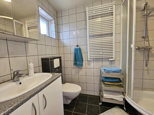 a bathroom with a sink and a toilet at Secret lagoon cabin in Fludir
