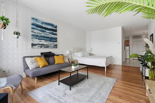 a living room with a couch and a bed at Condo St-Roch in Quebec City