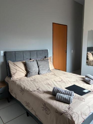 a large bed with pillows on it in a bedroom at The Riverside in Novo Acordo
