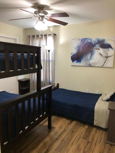 a bedroom with two beds and a ceiling fan at 4BR Cruise-Ready Home Walk to Moody Gardens Fenced Yard in Galveston