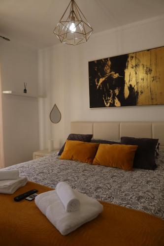 a bedroom with a bed with two towels on it at Apart Lisbon Airport in Lisbon