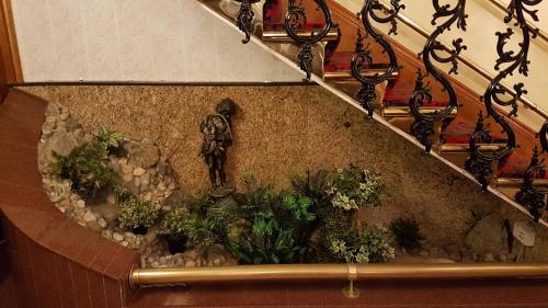 a stairway with a statue of a man on the side at Abbey Court Hotel - Hyde Park in London