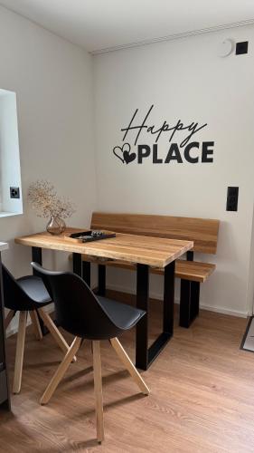 a table and chairs in a room with a sign on the wall at Gottlieber Rausch in Gottlieben