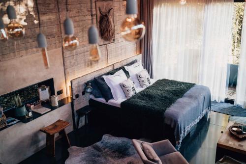 a bedroom with a bed with pillows at Le Loft "L'Atelier", petit déj inclus in Fauvillers