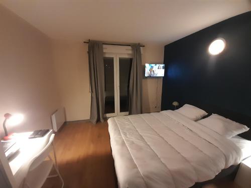 a bedroom with a large white bed with a black wall at Sweet Lodge in Échirolles