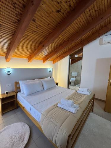 a bedroom with a large bed with towels on it at Blessed guest house in Shkodër