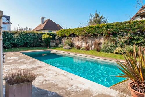 a swimming pool in the backyard of a house at la villa avezard in Blonville-sur-Mer