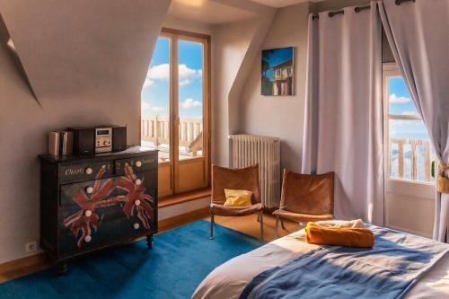 a bedroom with a bed and a window with a view at la villa avezard in Blonville-sur-Mer