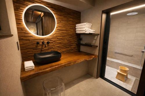 a bathroom with a sink and a mirror at 宮島 Shinwa in Miyajima