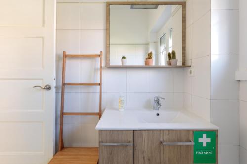 a bathroom with a sink and a mirror at Lovely Apartment to Stay in Lisbon