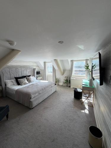 a bedroom with a large bed and a television at Durham Central Suites in Gilesgate