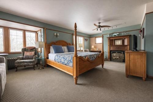 a bedroom with a bed and a tv and a fireplace at Cecil Bacon Manor in Seattle