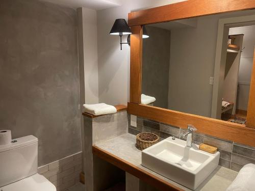 a bathroom with a sink and a mirror at eastwood in San Carlos