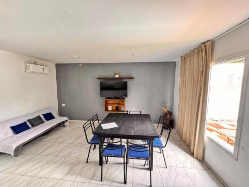 a living room with a table and chairs and a bed at casa villa azul 1 in Tanti