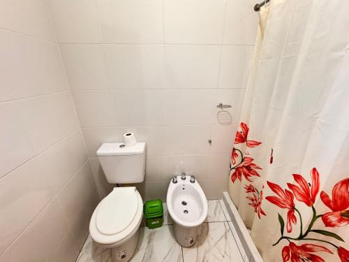 a bathroom with a toilet and a shower curtain at casa villa azul 1 in Tanti