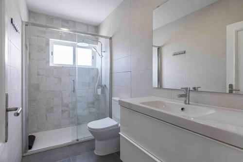a bathroom with a toilet and a sink and a shower at Carcavelos Village III By Staycalm in Carcavelos