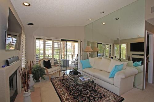a living room with a white couch and a fireplace at Balcony-Views-Country Club Living-VV667 in Palm Desert
